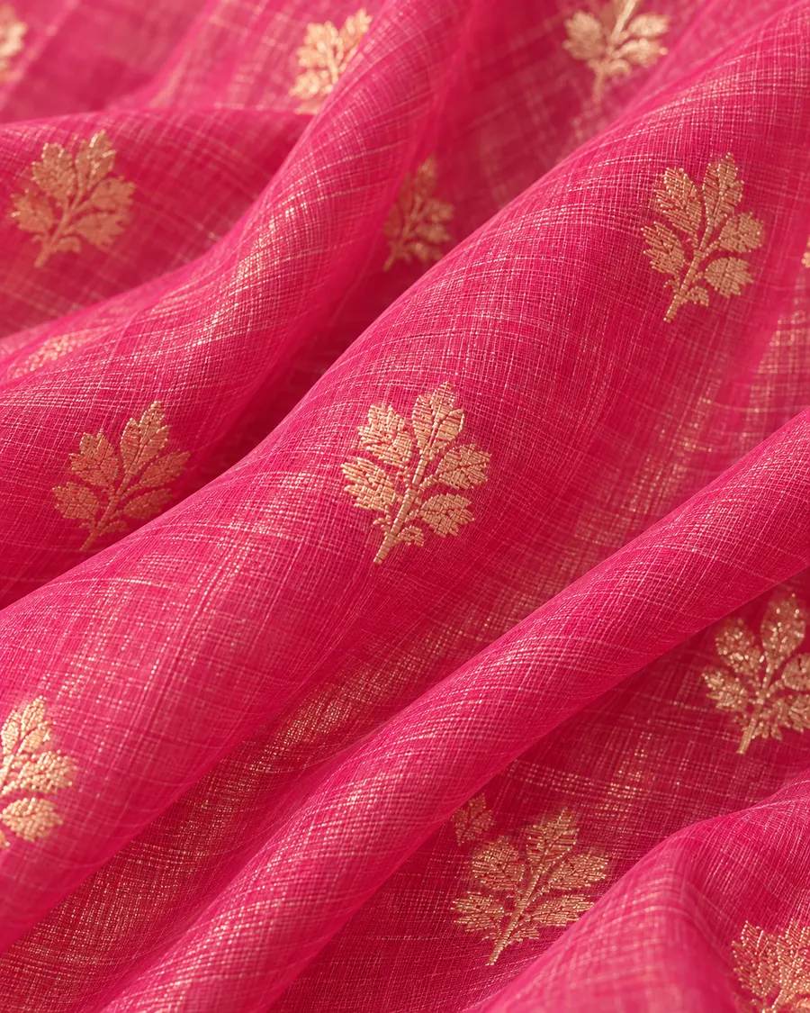 Close-up of the rani pink Chanderi weave, scattered with small hand-woven gold butis.